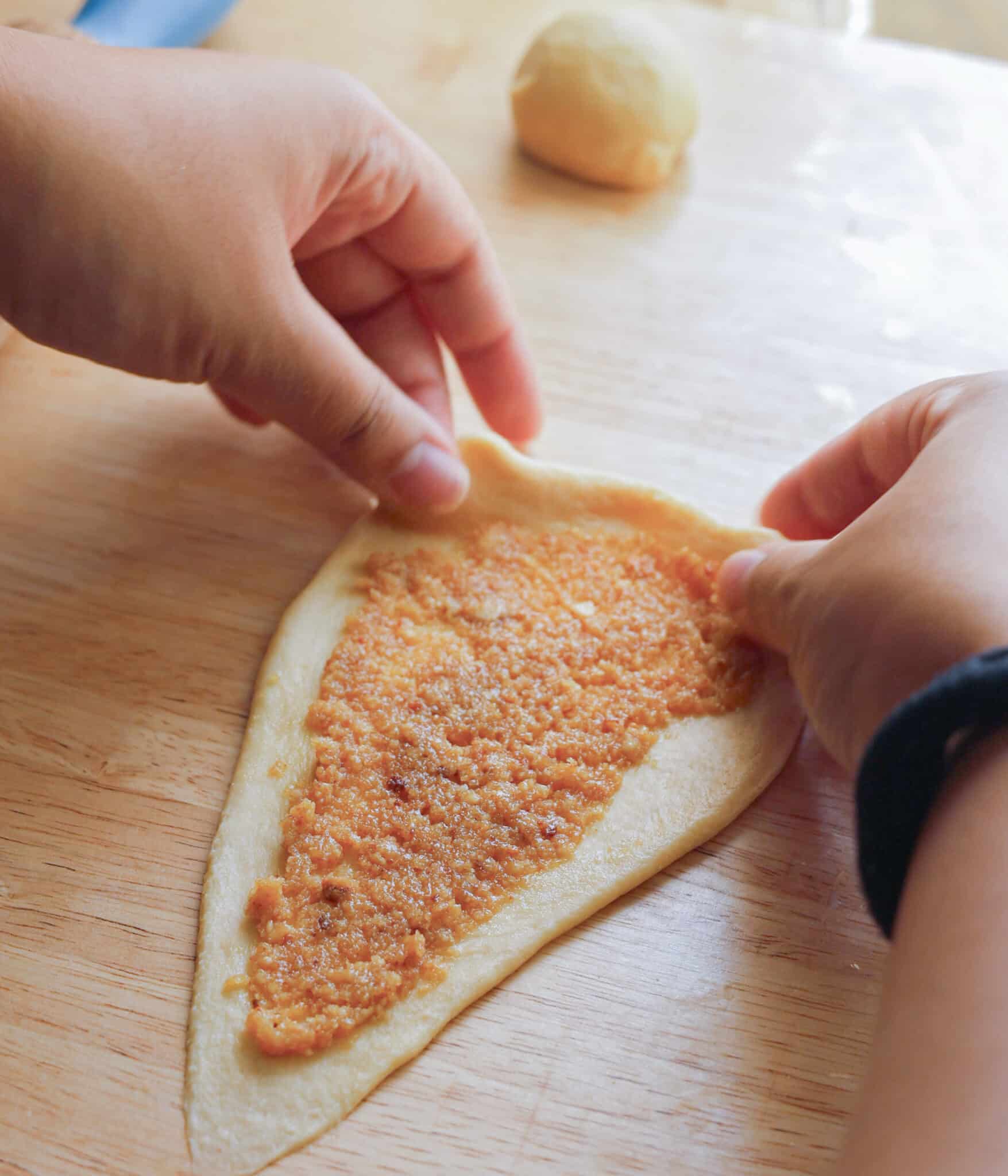 Shaping Spanish bread dough into rolls.