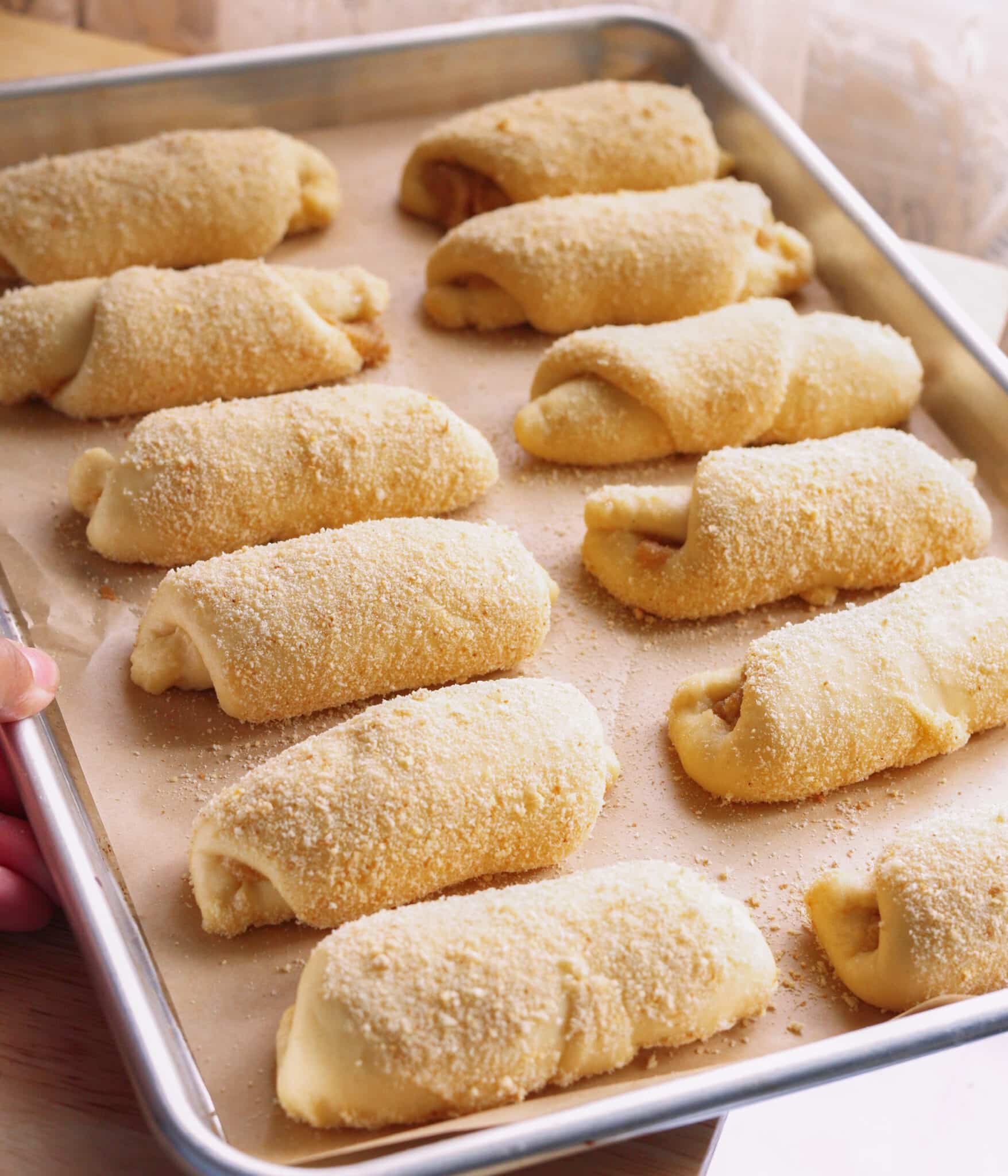 Spanish bread on a lined baking sheet ready to be baked in the oven.